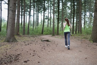 Woman jogging in forest. The Netherlands, Erp.
Photo : Mark de Leeuw
