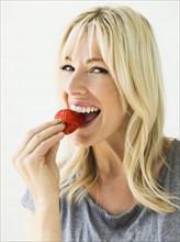 Woman eating fresh strawberry.
Photo : Jessica Peterson