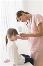 Doctor examining girl (4-5).