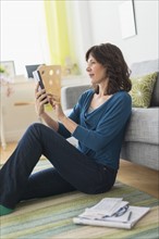 Woman using tablet pc at home.