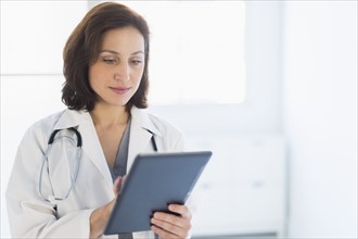 Female doctor using digital tablet.