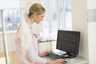Female nurse working on computer.