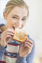 Woman eating toast.