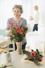 Woman arranging bouquet.