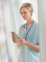 Female nurse using tablet PC.