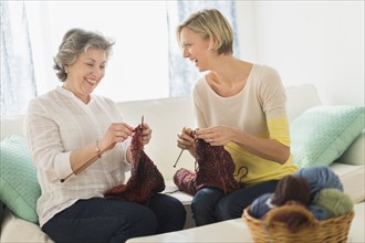 Two mature women knitting.