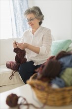 Mature woman knitting.
