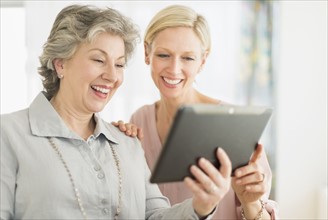 Portrait of two women using digital tablet.