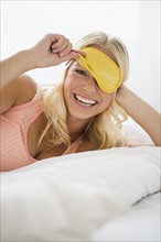 Portrait of smiling woman with eye mask on. .
Photo : Jamie Grill