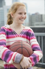 Portrait of girl (12-13) holding ball.
Photo : Jamie Grill