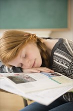 Girl (12-13) sleeping on desk.
Photo : Jamie Grill