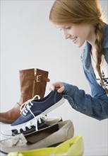 Girl (12-13) choosing shoes.
Photo : Jamie Grill