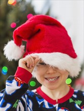Boy (6-7) peeking through santa hat.
Photo : Daniel Grill