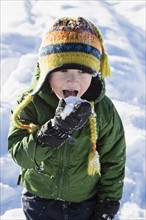 Boy (4-5) checking taste of snow.
Photo : Maisie Paterson