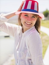Portrait of young woman wearing hat with pattern of american flag. Salt Lake City, Utah, USA