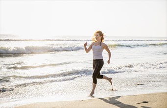 Woman running on beach.