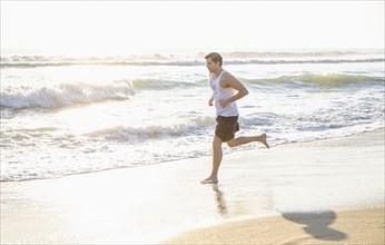 Man running on beach.