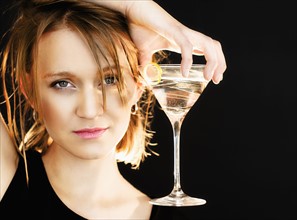 Portrait of woman holding martini glass.