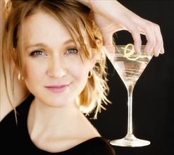 Portrait of woman holding martini glass.