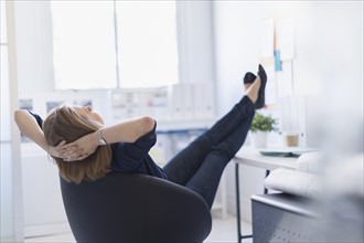 Business woman relaxing in office.