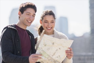 Young couple looking at map.
