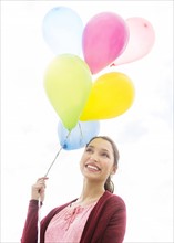 Young woman with colorful balloons.