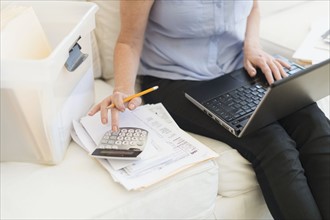 Woman paying bills via internet.