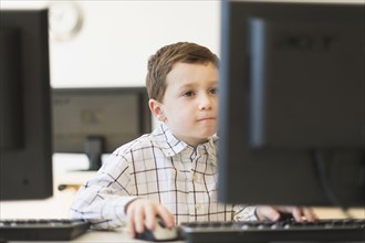 boy (6-7) using computer.