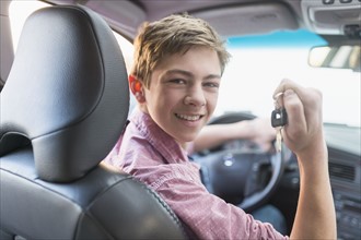 Teenage boy (16-17) driving his first car.