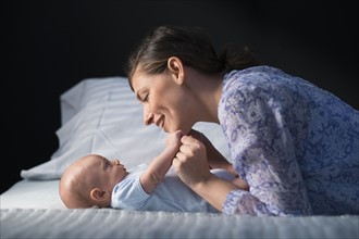 Woman playing with baby boy (2-5 months).