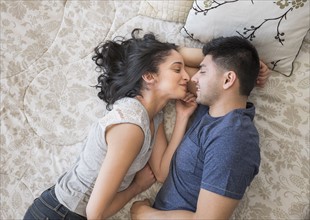 Young couple lying on bed.