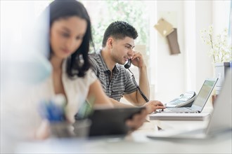 Young man and woman working in office.