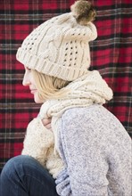 Profile of woman wearing knit hat and scarf.
Photo : Jamie Grill
