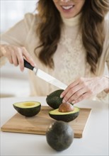 Woman cutting avocados.
Photo : Jamie Grill