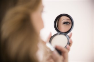 Woman applying makeup.
Photo : Jamie Grill