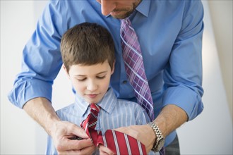 Father adjusting son's(8-9) tie .
Photo : Jamie Grill