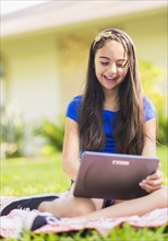 girl ( 8-9) using digital tablet .
Photo : Daniel Grill