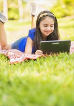 girl ( 8-9) using digital tablet.
Photo : Daniel Grill