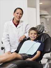 Portrait of dentist with patient( 12-13).