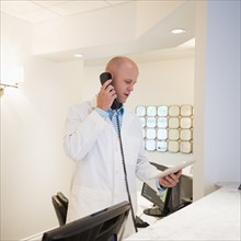 Doctor talking on phone.