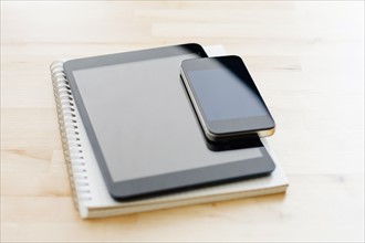 Studio shot of digital tablet, Mobile phone and spiral notebook.
Photo : Kristin Lee