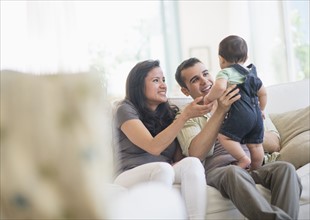 Family with baby son (6-11 months) in living room.