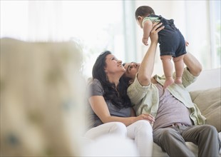 Family with baby son (6-11 months) in living room.