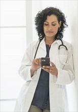Female doctor using cell phone.