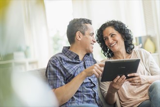 Couple using digital tablet.