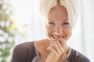 Portrait of happy blonde woman smiling.