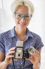 Woman holding vintage camera.