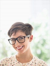 Portrait of smiling woman wearing eyeglasses.