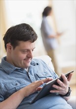 Man with down syndrome using tablet.