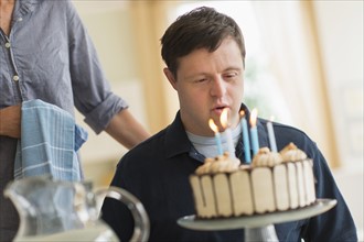 Man with down syndrome celebrating birthday.